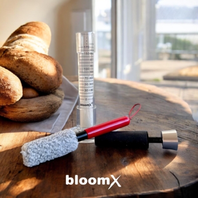 Baker using BloomX Fermentation Tracker in a home kitchen